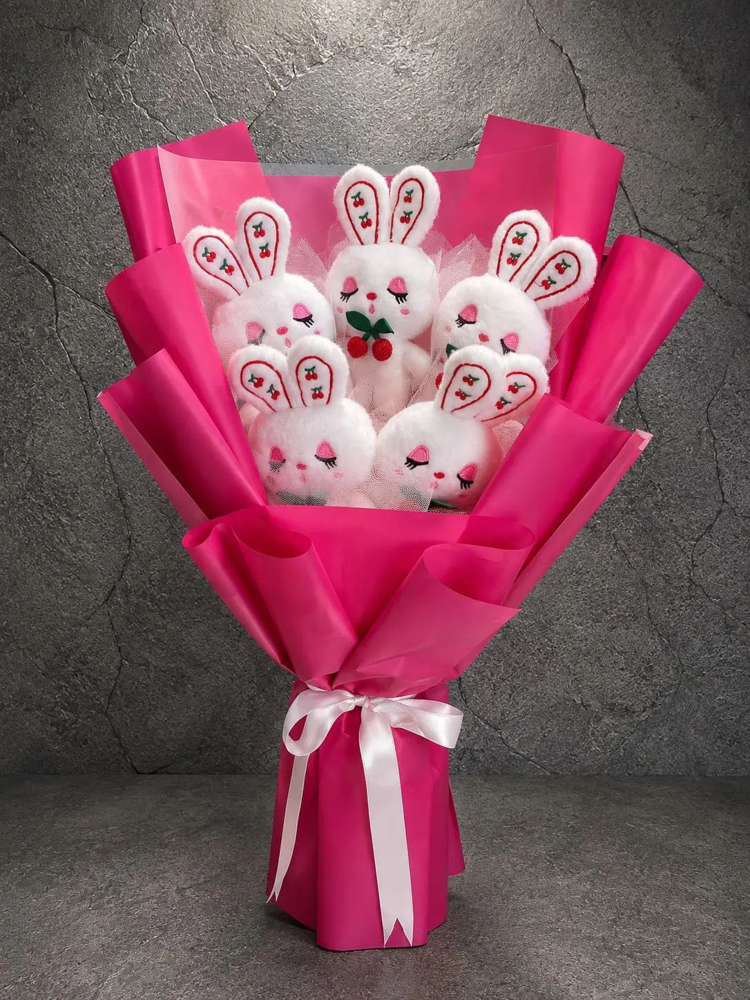 Kirazlı Tavşanlar Peluş Buketi AYB0006 Kirazlı Tavşanlar Peluş Buketi fuşya ambalajlı beş beyaz tavşan hediyesi